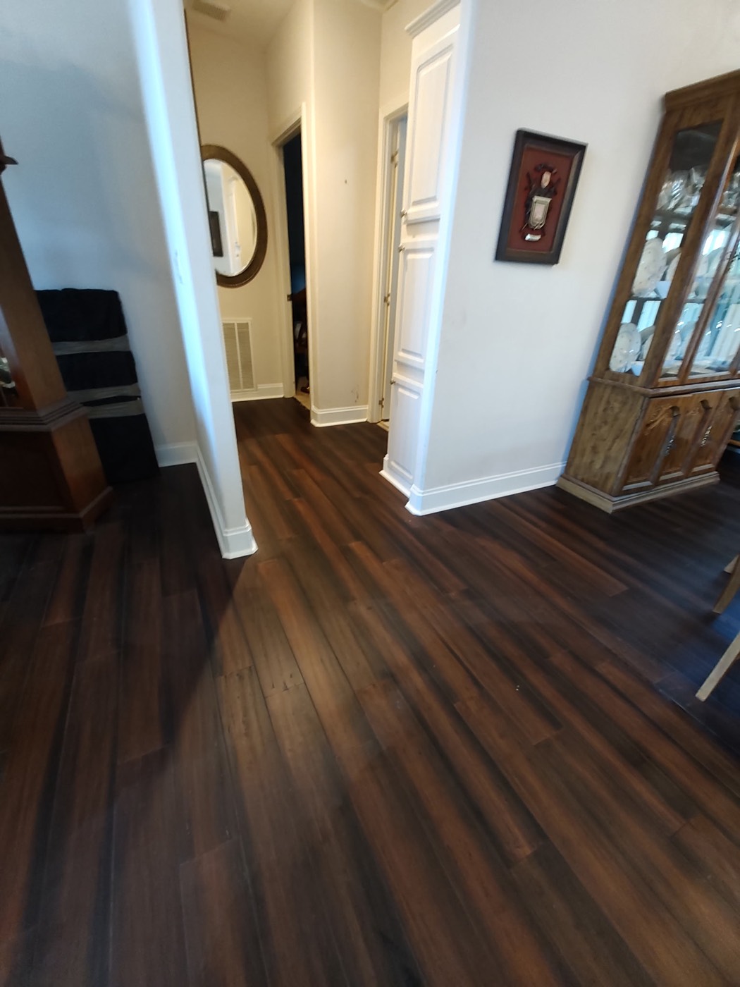 Dark wood plank flooring through a hallway